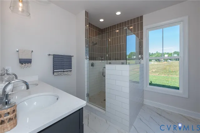 a bathroom with a shower sink and mirror
