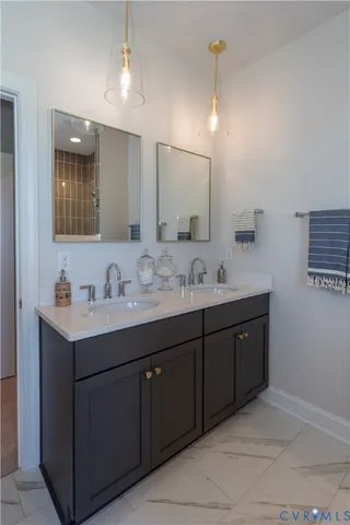 a bathroom with a sink vanity and mirror