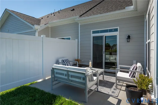 a building outdoor space with patio furniture and potted plants