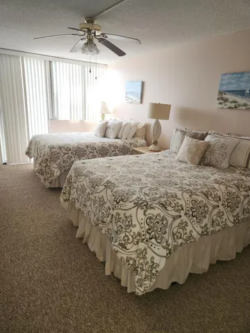 a bathroom with a double vanity sink and mirror with toilet
