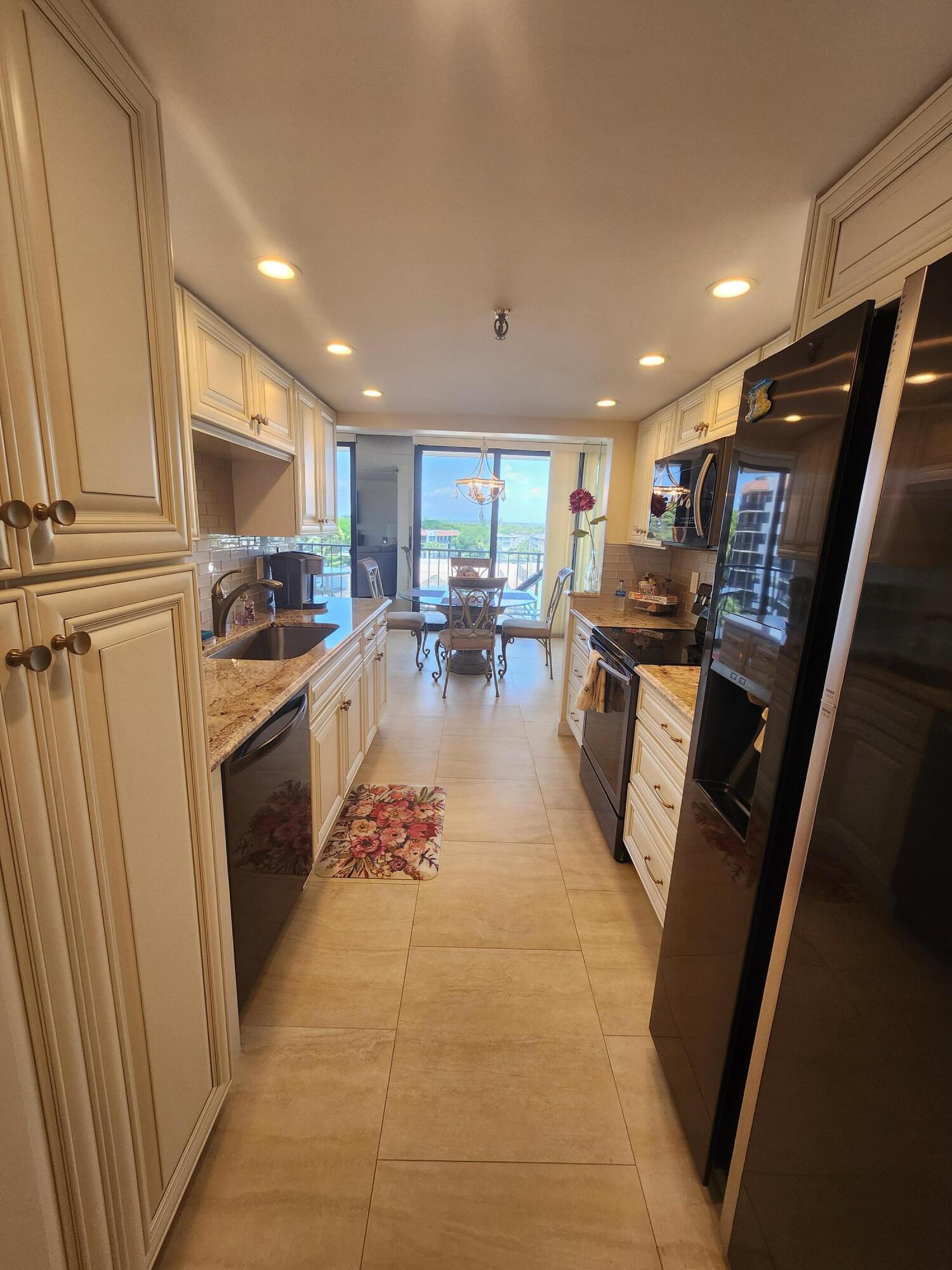 899 Jeffery Street, Unit 601 Boca Raton, FL 33487 - Photo 3 of 47 a kitchen with stainless steel appliances a refrigerator a sink a stove a microwave and cabinets