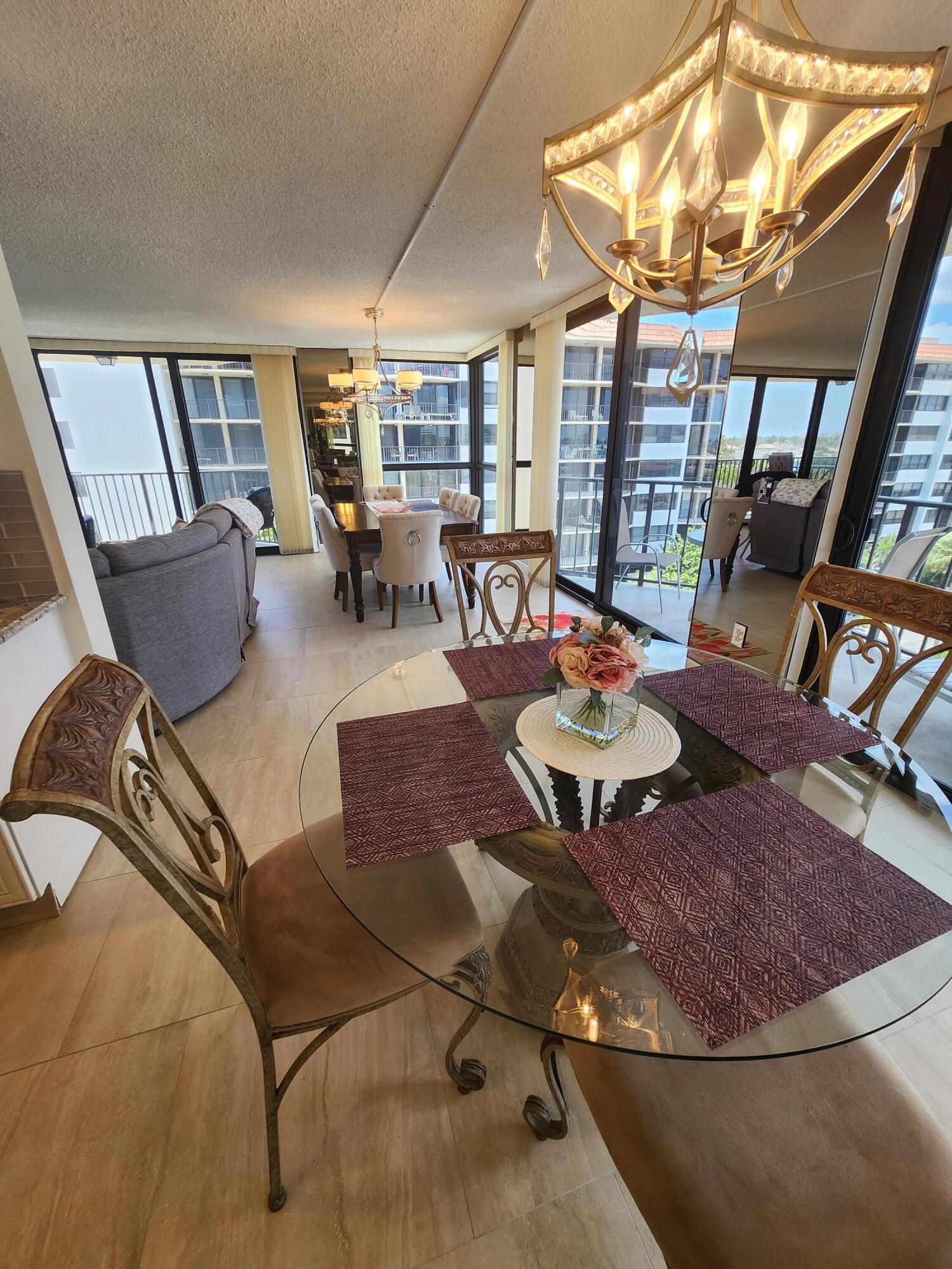 899 Jeffery Street, Unit 601 Boca Raton, FL 33487 - Photo 8 of 47 a living room with furniture and a dining table with wooden floor