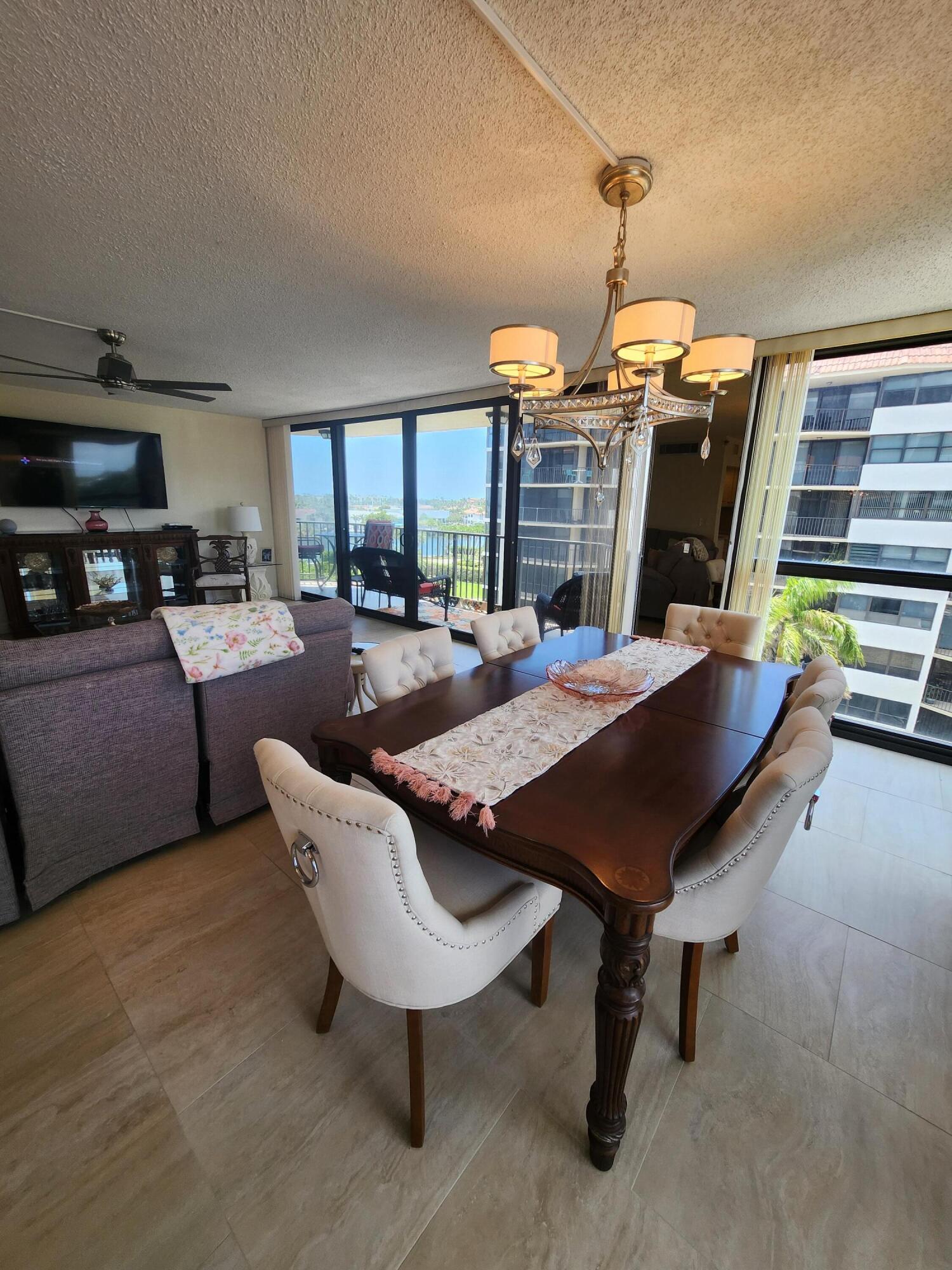 899 Jeffery Street, Unit 601 Boca Raton, FL 33487 - Photo 9 of 47 a dining room with furniture and a chandelier