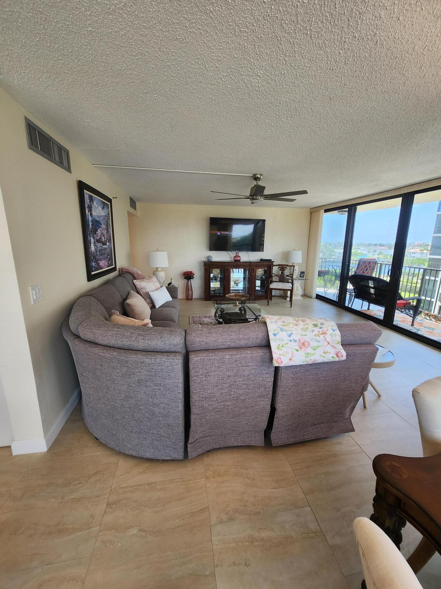 899 Jeffery Street, Unit 601 Boca Raton, FL 33487 - Photo 10 of 47 a living room with furniture and a flat screen tv