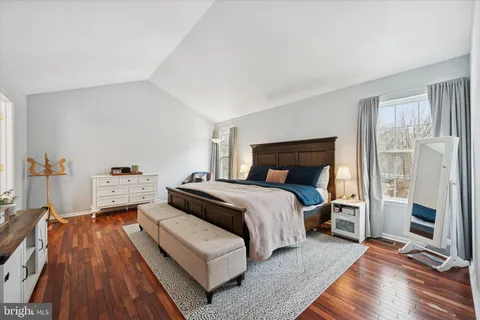 a bedroom with a bed and a mirror