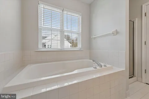 a white bath tub sitting next to a window