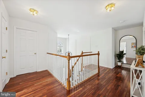 a view of a bedroom with wooden floor