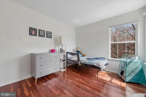 a bedroom with furniture and a wooden floor