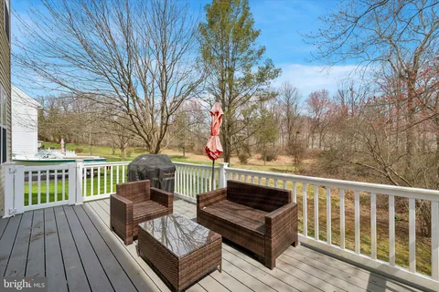 a view of balcony with wooden floor and outdoor seating