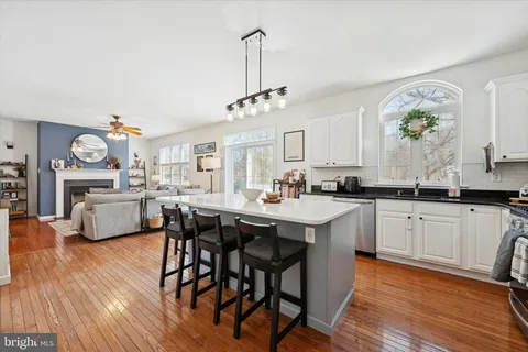 a kitchen with stainless steel appliances a dining table and chairs