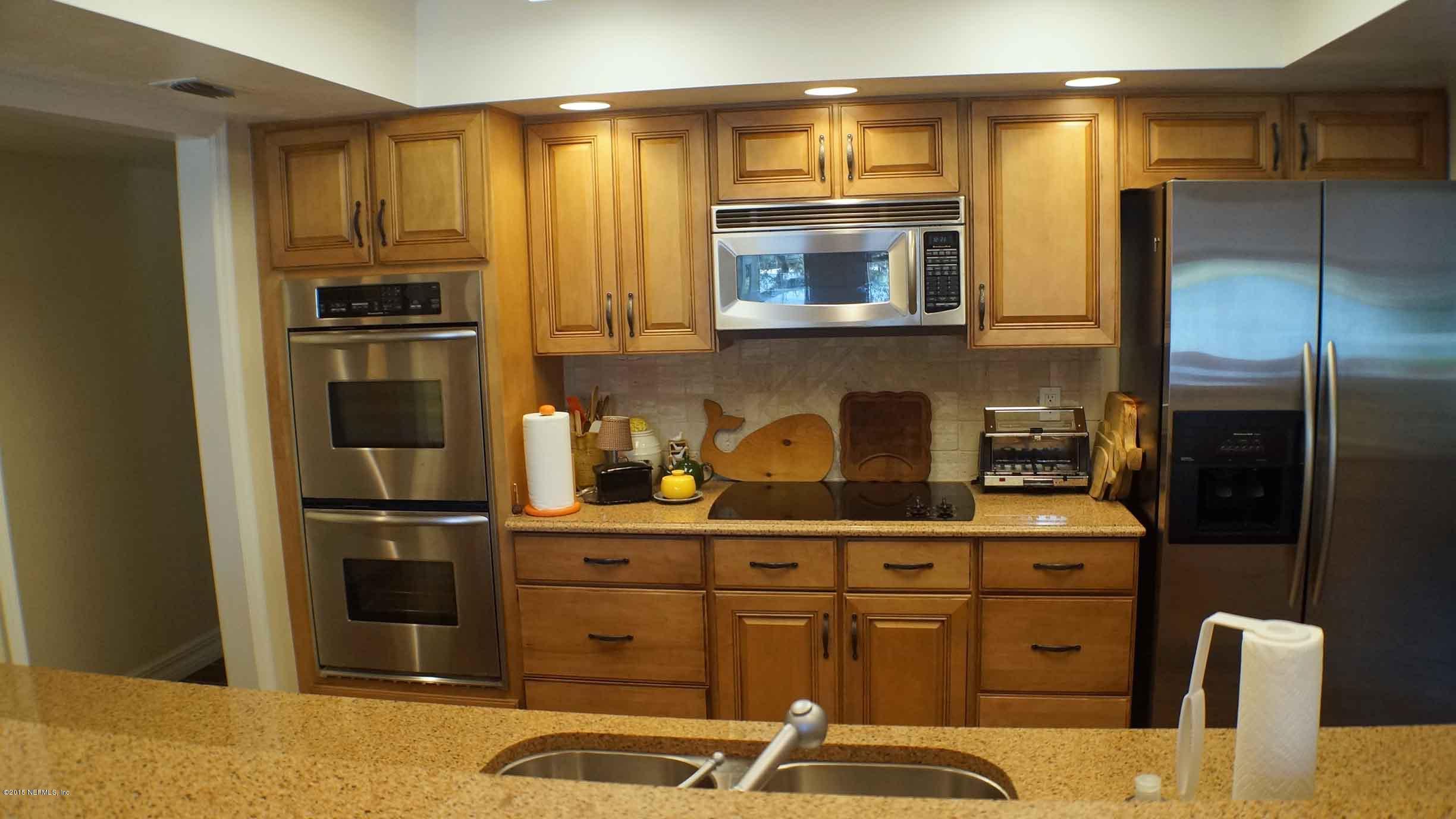 6674 Brooklyn Bay Road Keystone Heights, FL 32656 - Photo 14 of 57 a kitchen with a refrigerator and a stove top oven