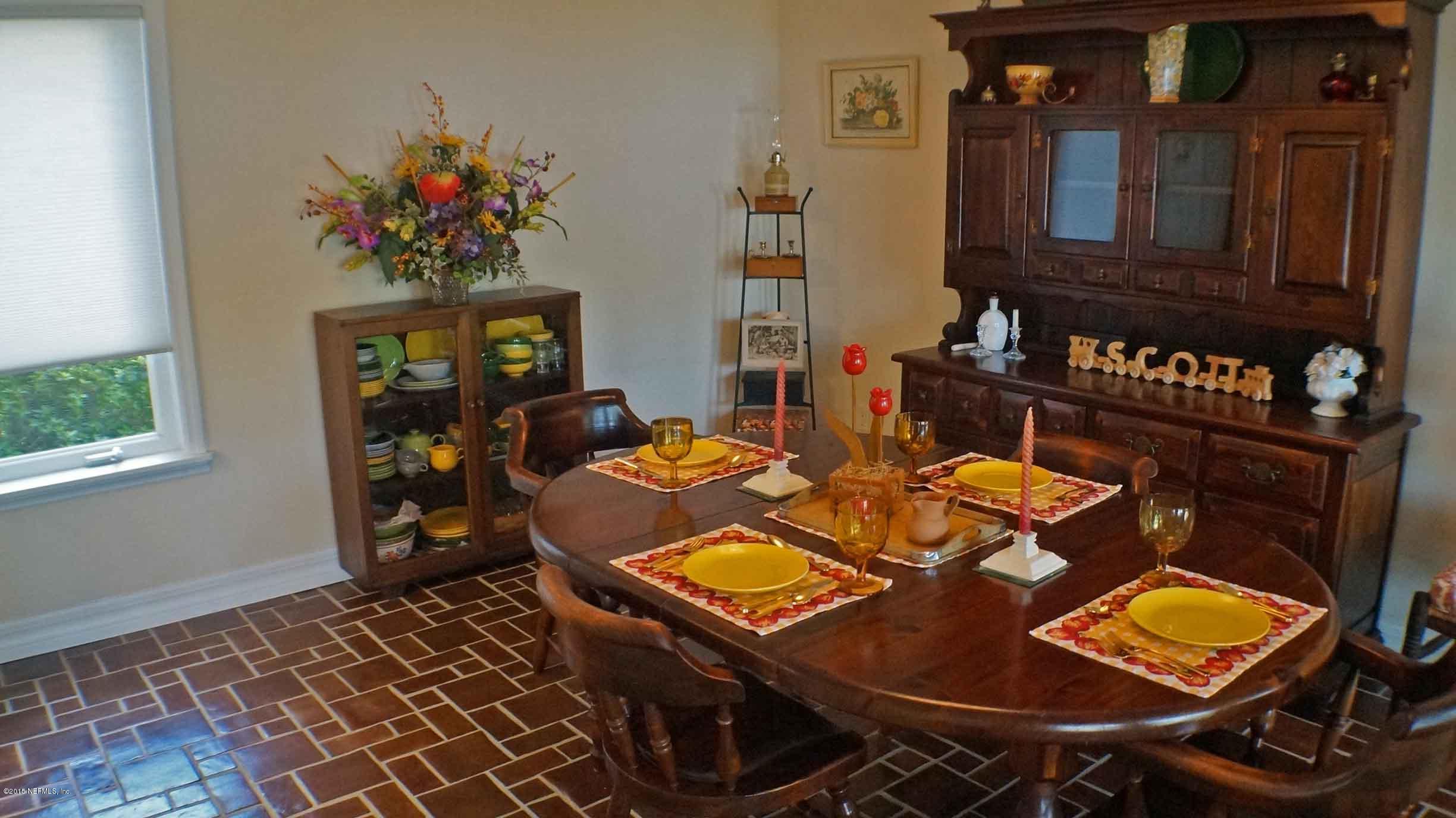 6674 Brooklyn Bay Road Keystone Heights, FL 32656 - Photo 17 of 57 a view of a dining room with furniture and chandelier