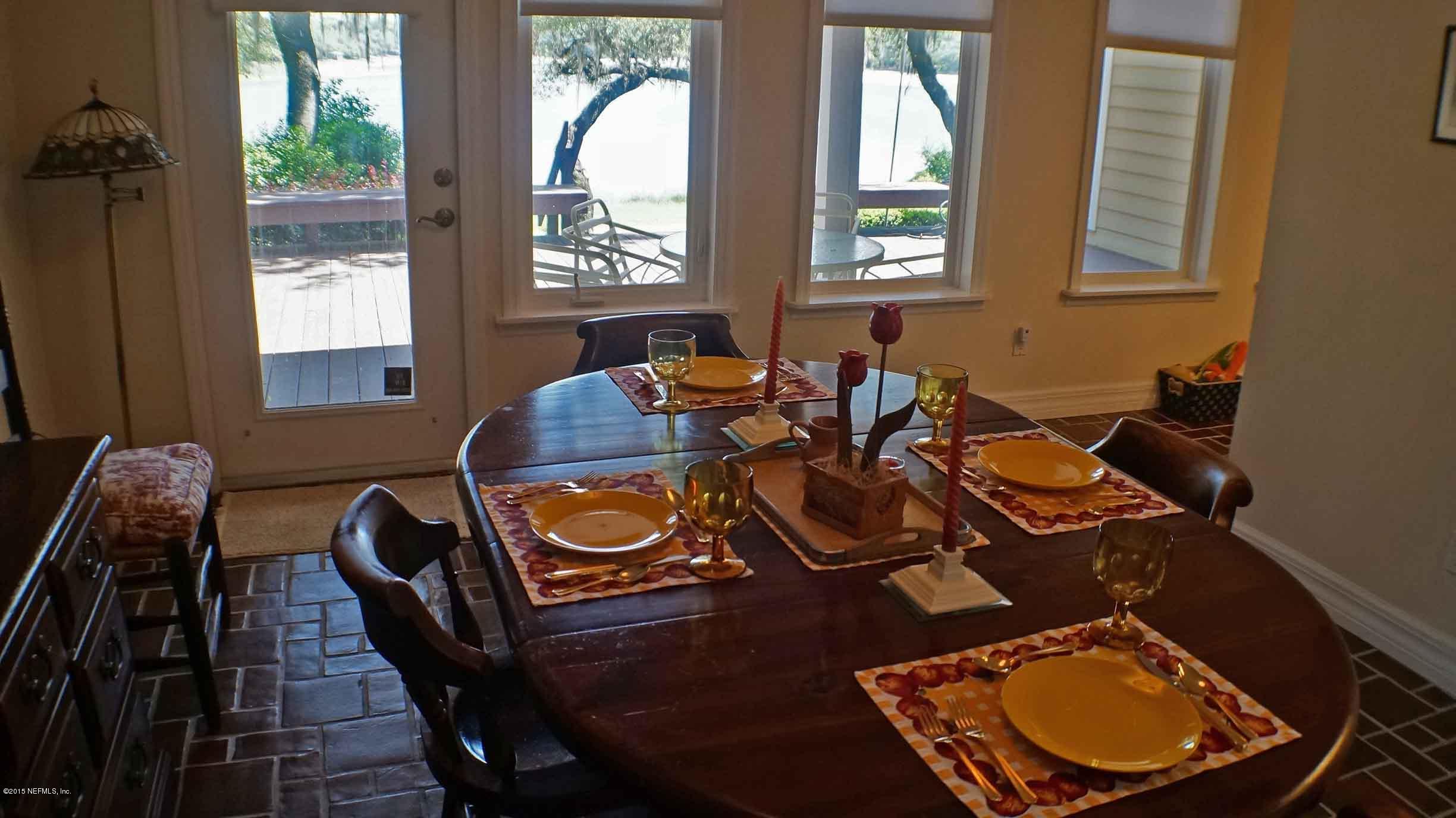 6674 Brooklyn Bay Road Keystone Heights, FL 32656 - Photo 19 of 57 a view of a patio with table and chairs