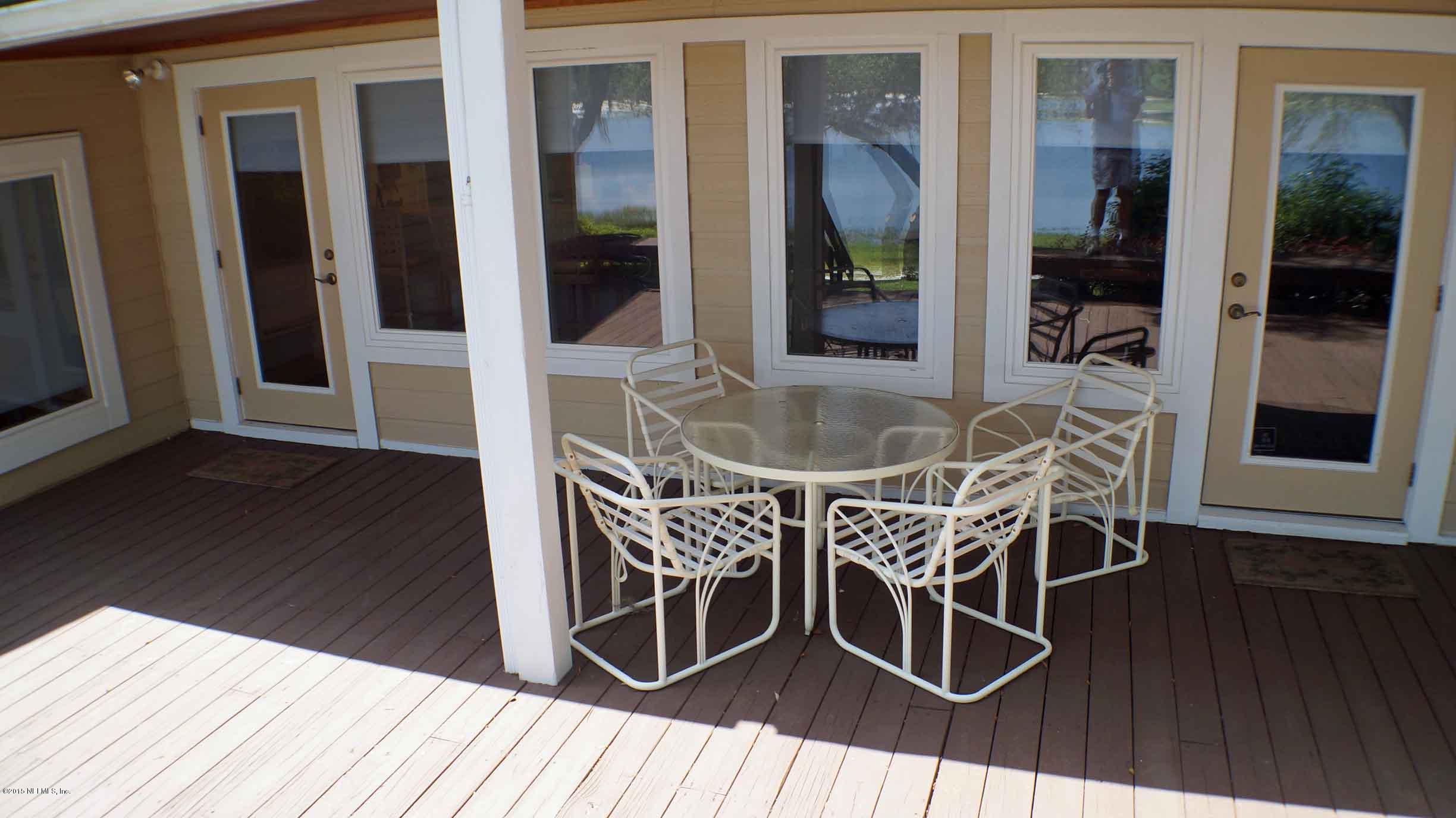 6674 Brooklyn Bay Road Keystone Heights, FL 32656 - Photo 20 of 57 a dining room with furniture and wooden floor