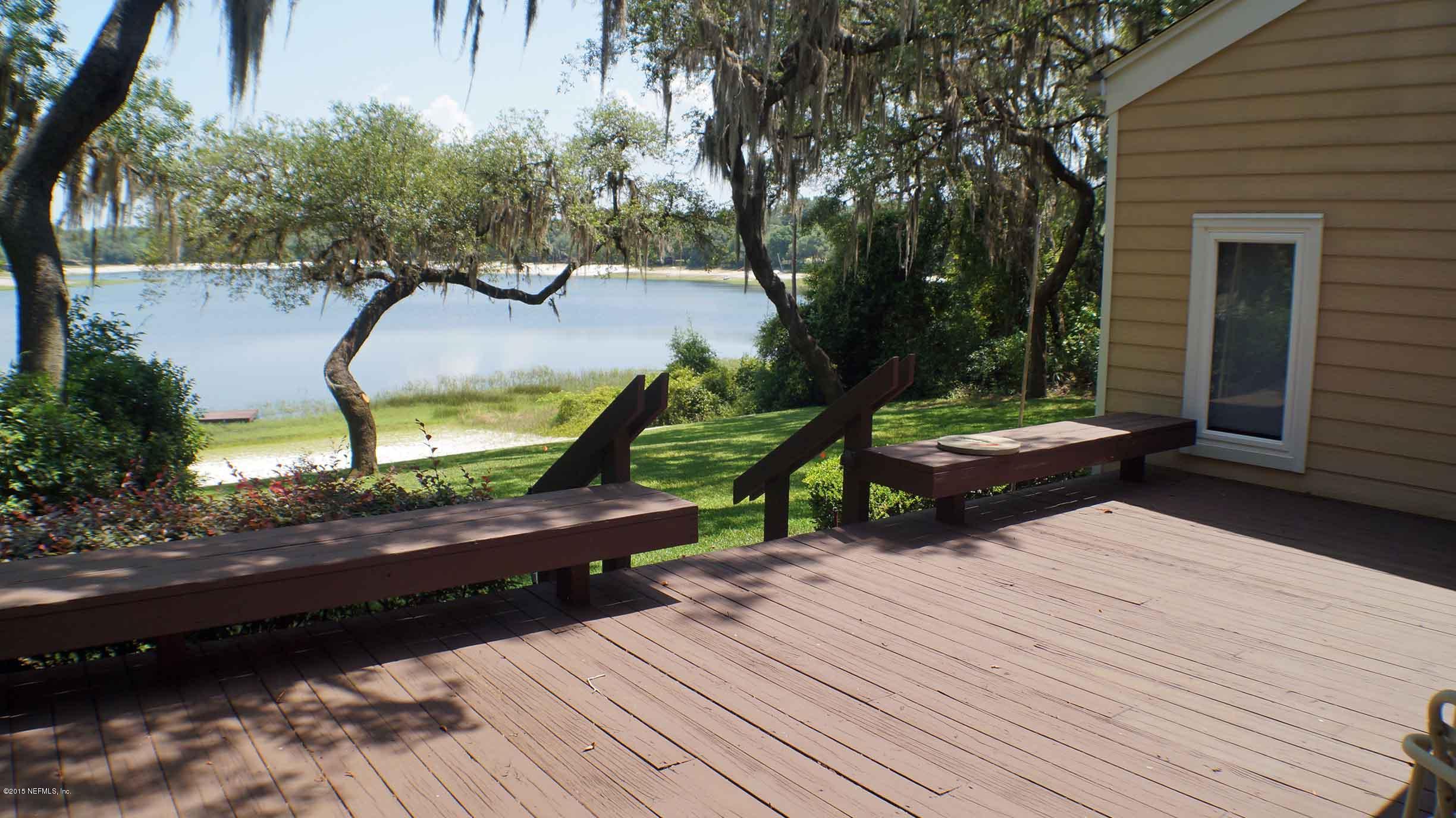 6674 Brooklyn Bay Road Keystone Heights, FL 32656 - Photo 24 of 57 a backyard of a house with wooden floor and outdoor seating