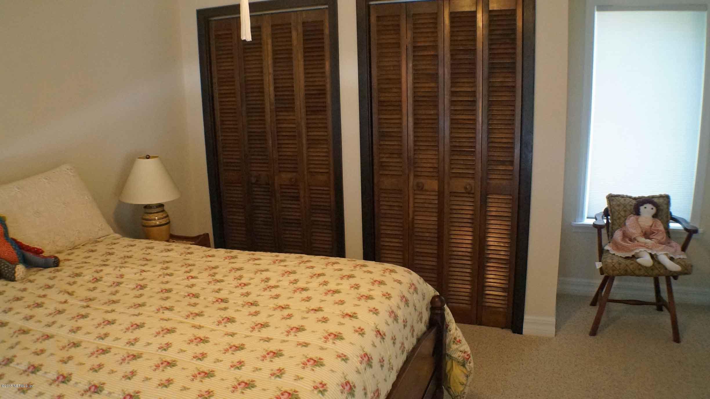 6674 Brooklyn Bay Road Keystone Heights, FL 32656 - Photo 30 of 57 a bedroom with a bed and a chair