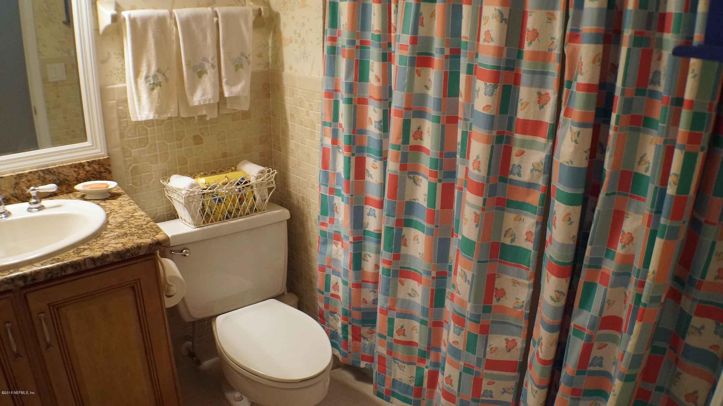6674 Brooklyn Bay Road Keystone Heights, FL 32656 - Photo 38 of 57 a white toilet sitting next to a sink a rug