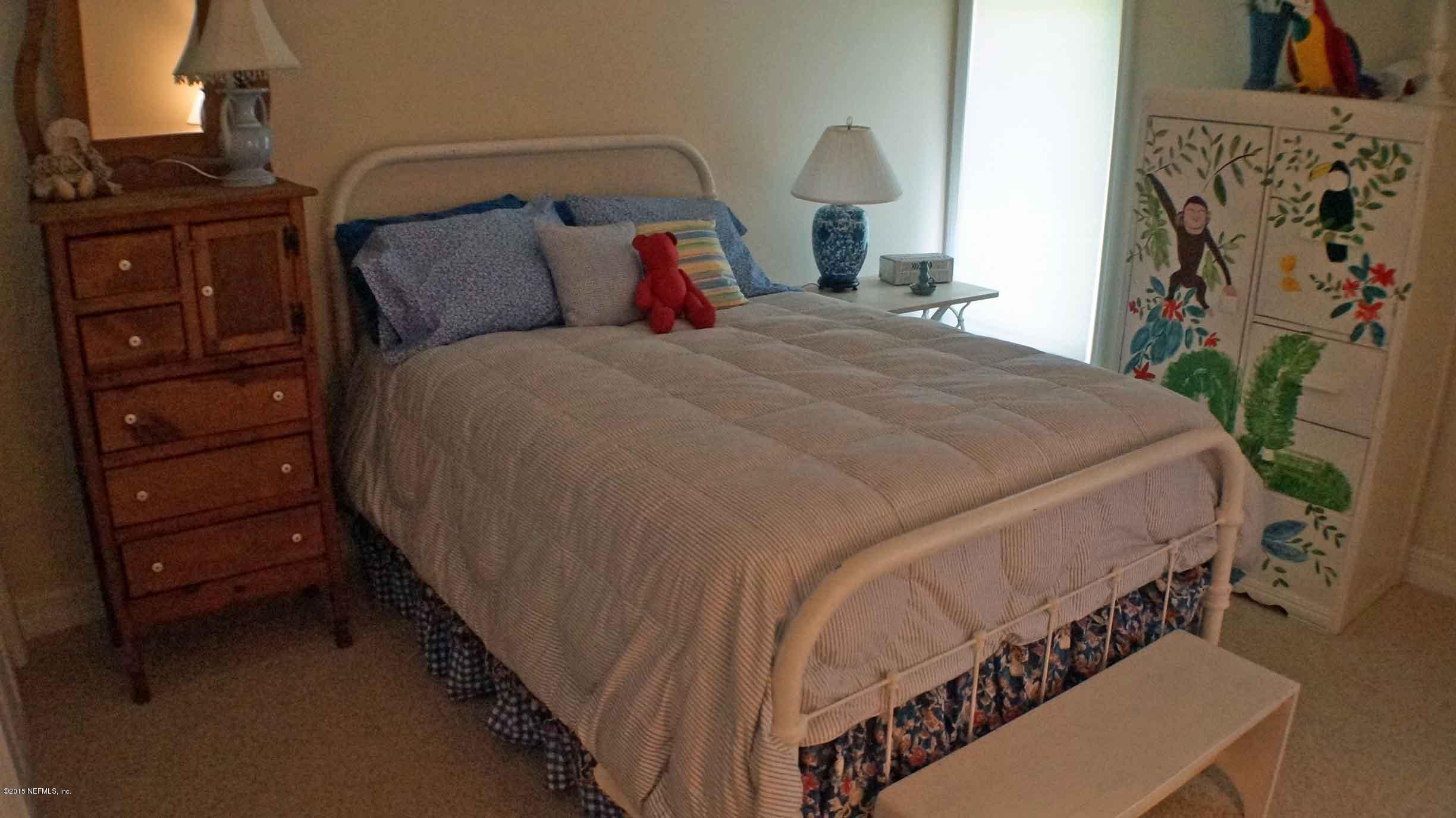 6674 Brooklyn Bay Road Keystone Heights, FL 32656 - Photo 40 of 57 a bed sitting in a bedroom next to a lamp and a window