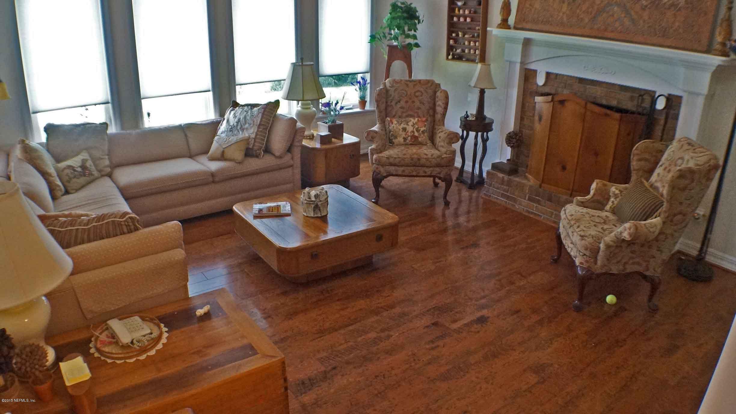 6674 Brooklyn Bay Road Keystone Heights, FL 32656 - Photo 42 of 57 a living room with furniture wooden floor and a large window