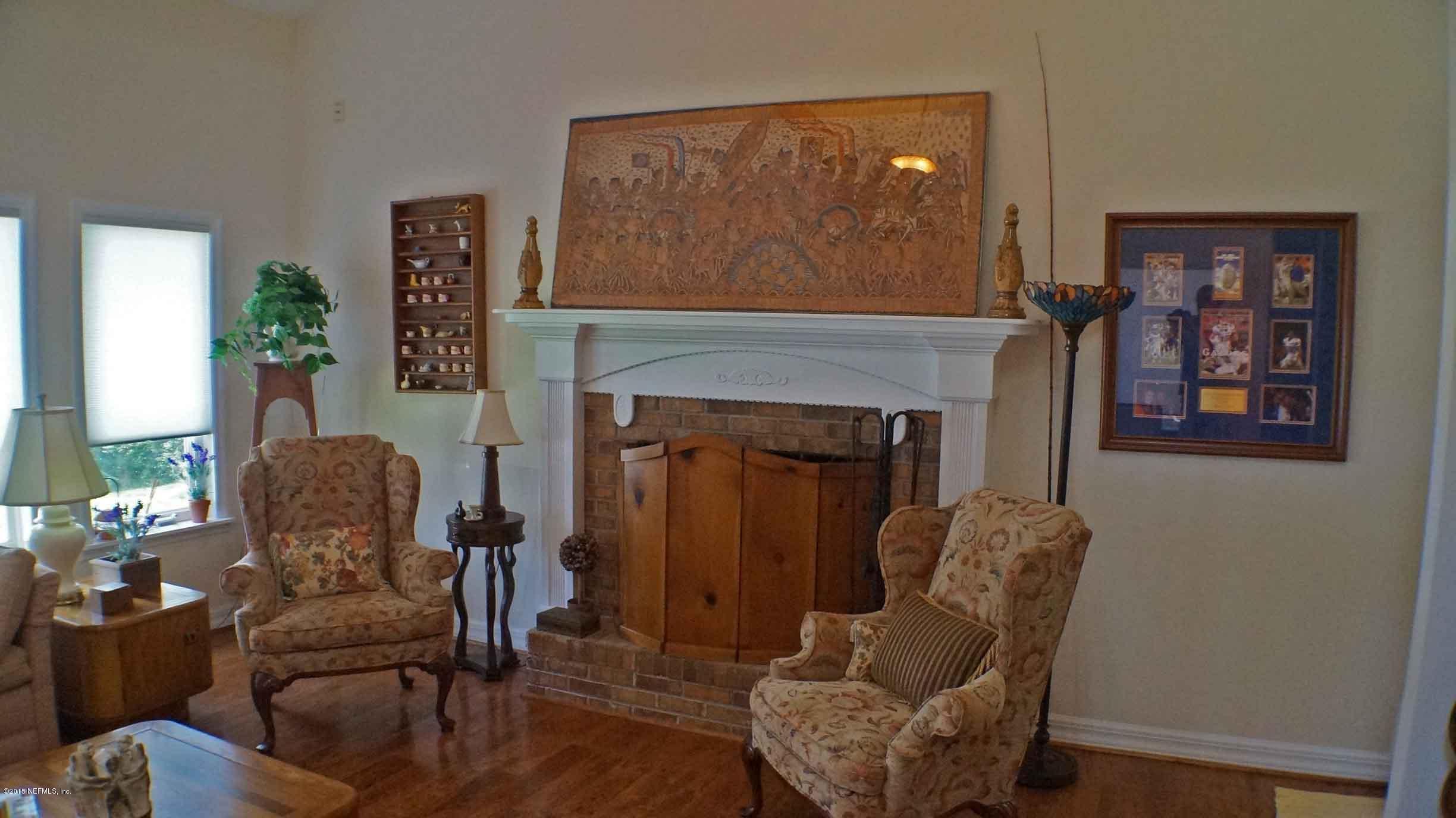 6674 Brooklyn Bay Road Keystone Heights, FL 32656 - Photo 43 of 57 a living room with furniture and a fireplace