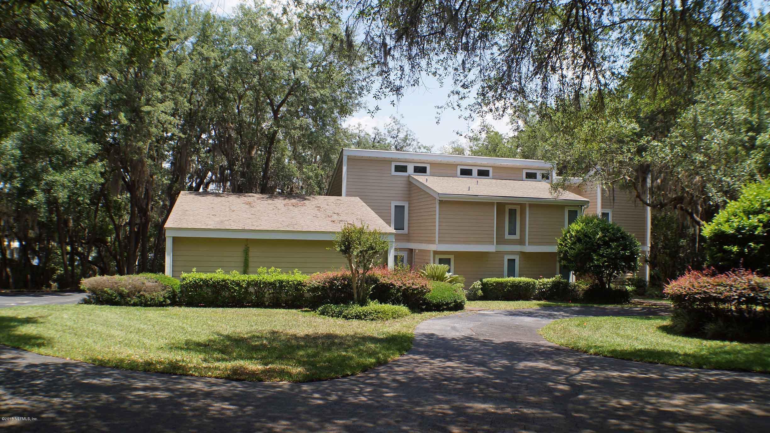 6674 Brooklyn Bay Road Keystone Heights, FL 32656 - Photo 54 of 57 a view of a white house with a yard plants and large tree