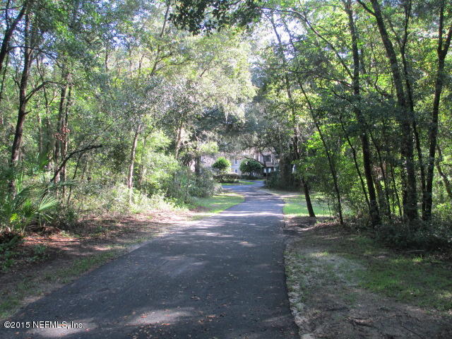 6674 Brooklyn Bay Road Keystone Heights, FL 32656 - Photo 57 of 57 a view of a road with trees in the background