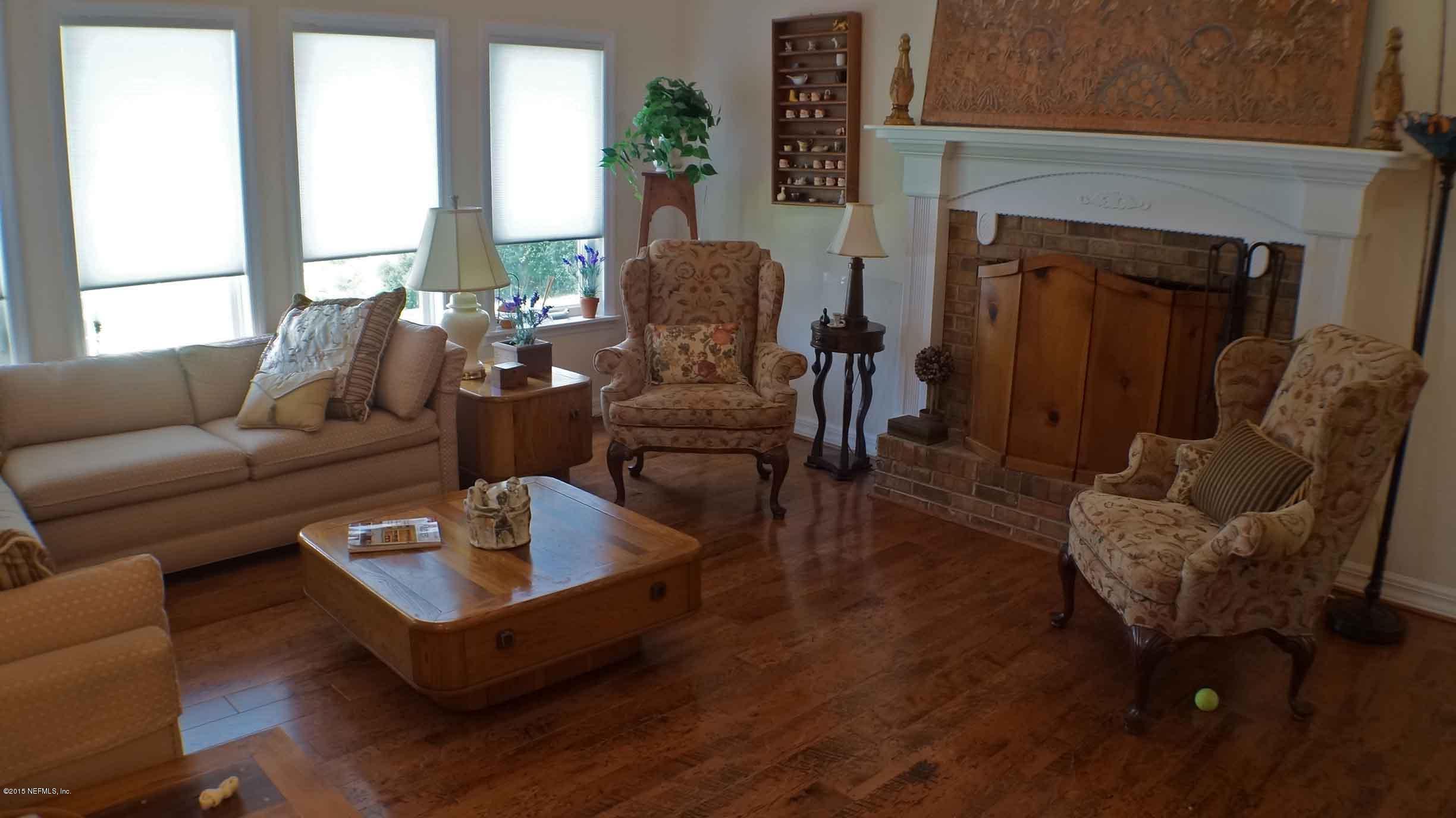 6674 Brooklyn Bay Road Keystone Heights, FL 32656 - Photo 9 of 57 a living room with furniture and a fireplace
