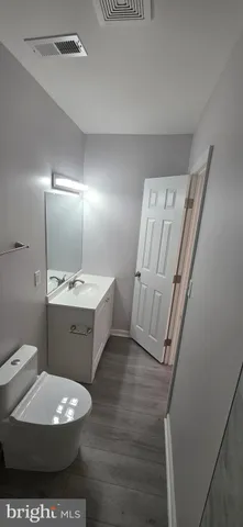 a bathroom with a sink a toilet a mirror and vanity