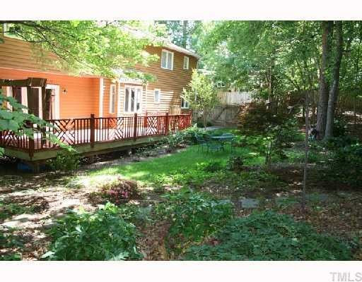 Fenced and beautifully landscaped backyard with lots of trees for privacy. Exterior Back