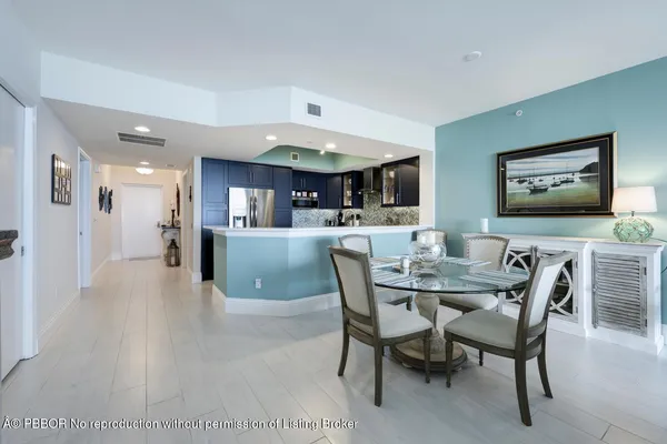 a living room with furniture large windows and a flat screen tv