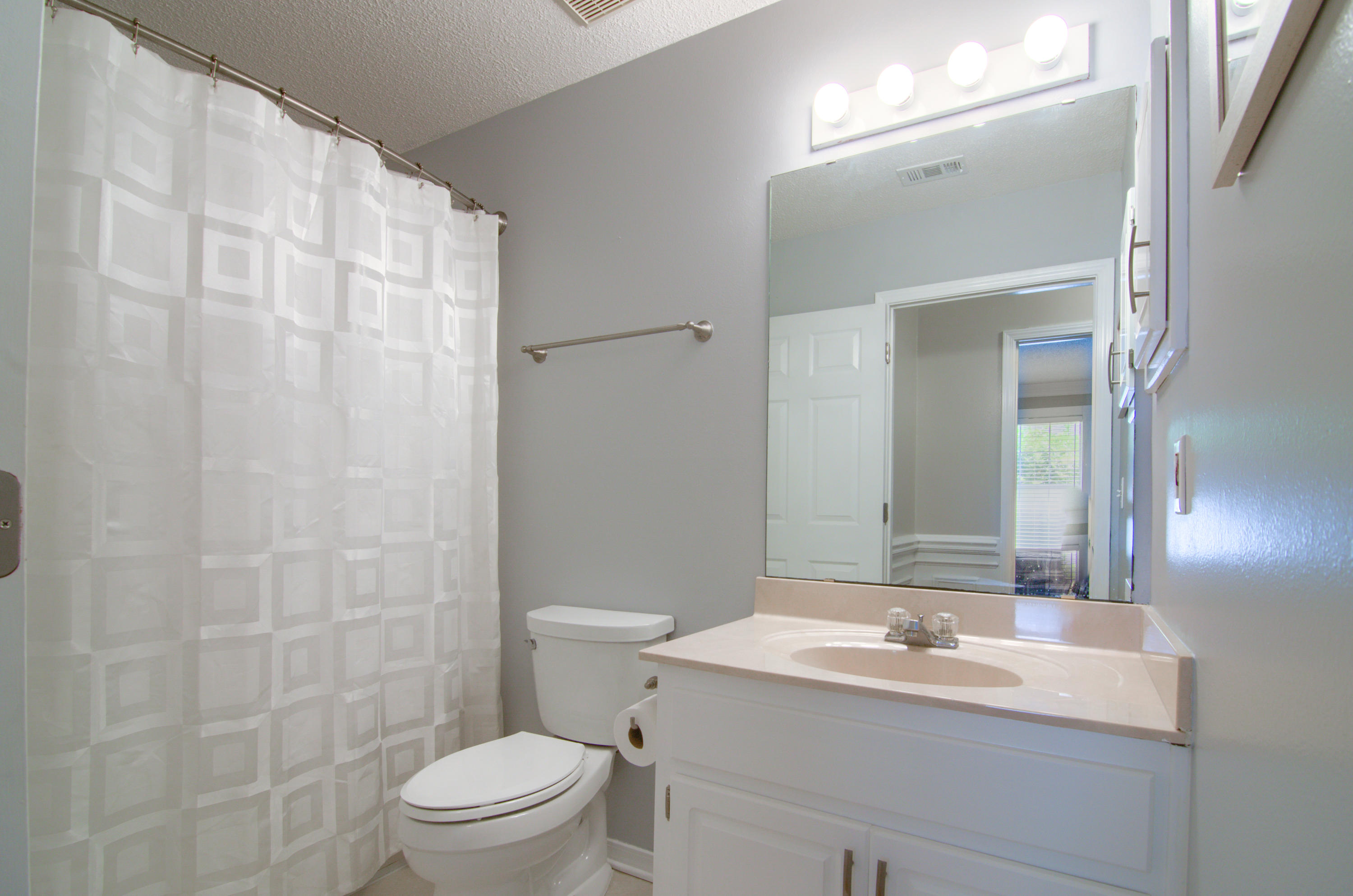 3840 Mesa Road Destin, FL 32541 - Photo 4 of 11 a bathroom with a sink a toilet a mirror and shower