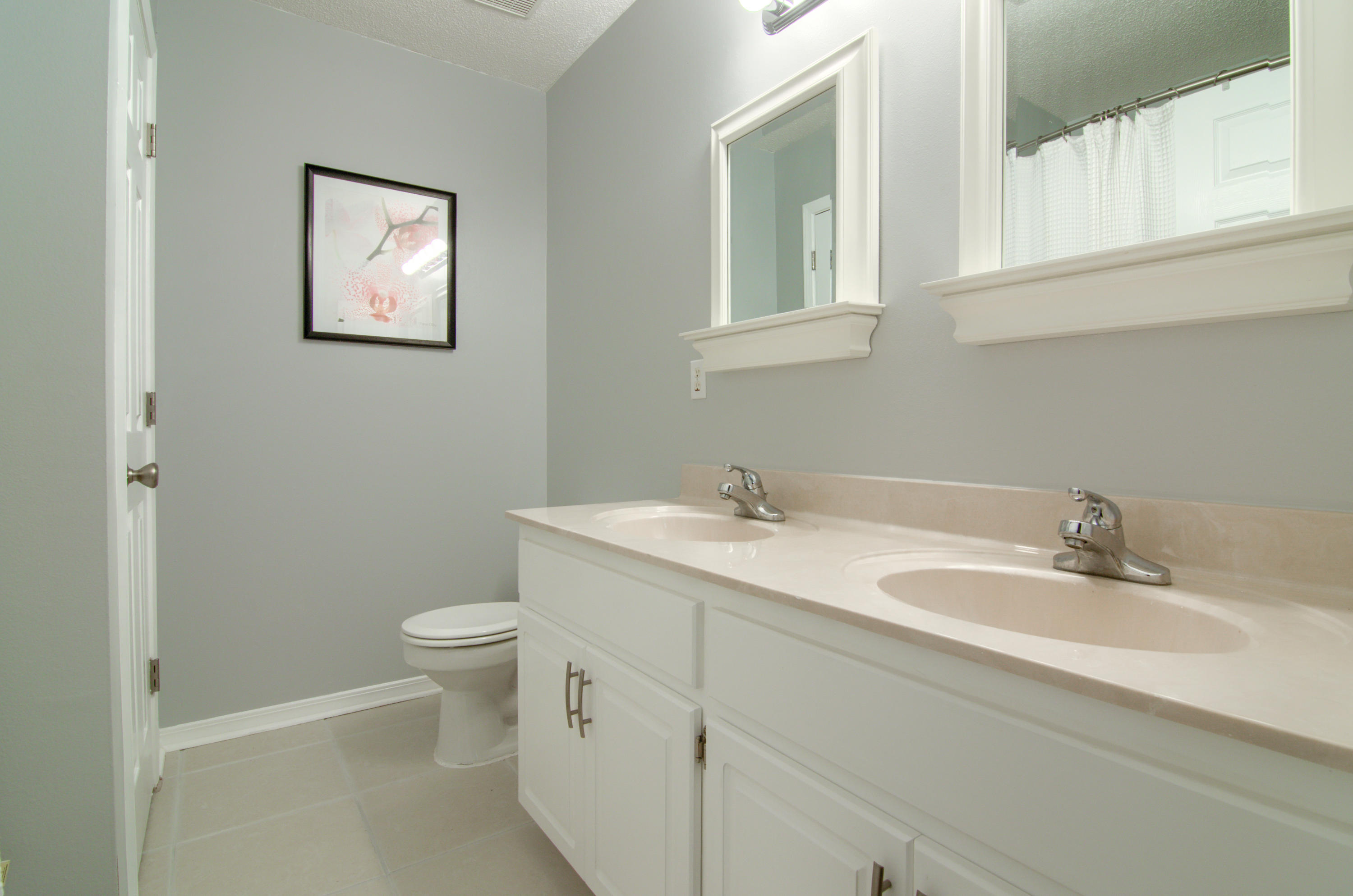 3840 Mesa Road Destin, FL 32541 - Photo 6 of 11 a bathroom with a toilet sink and mirror