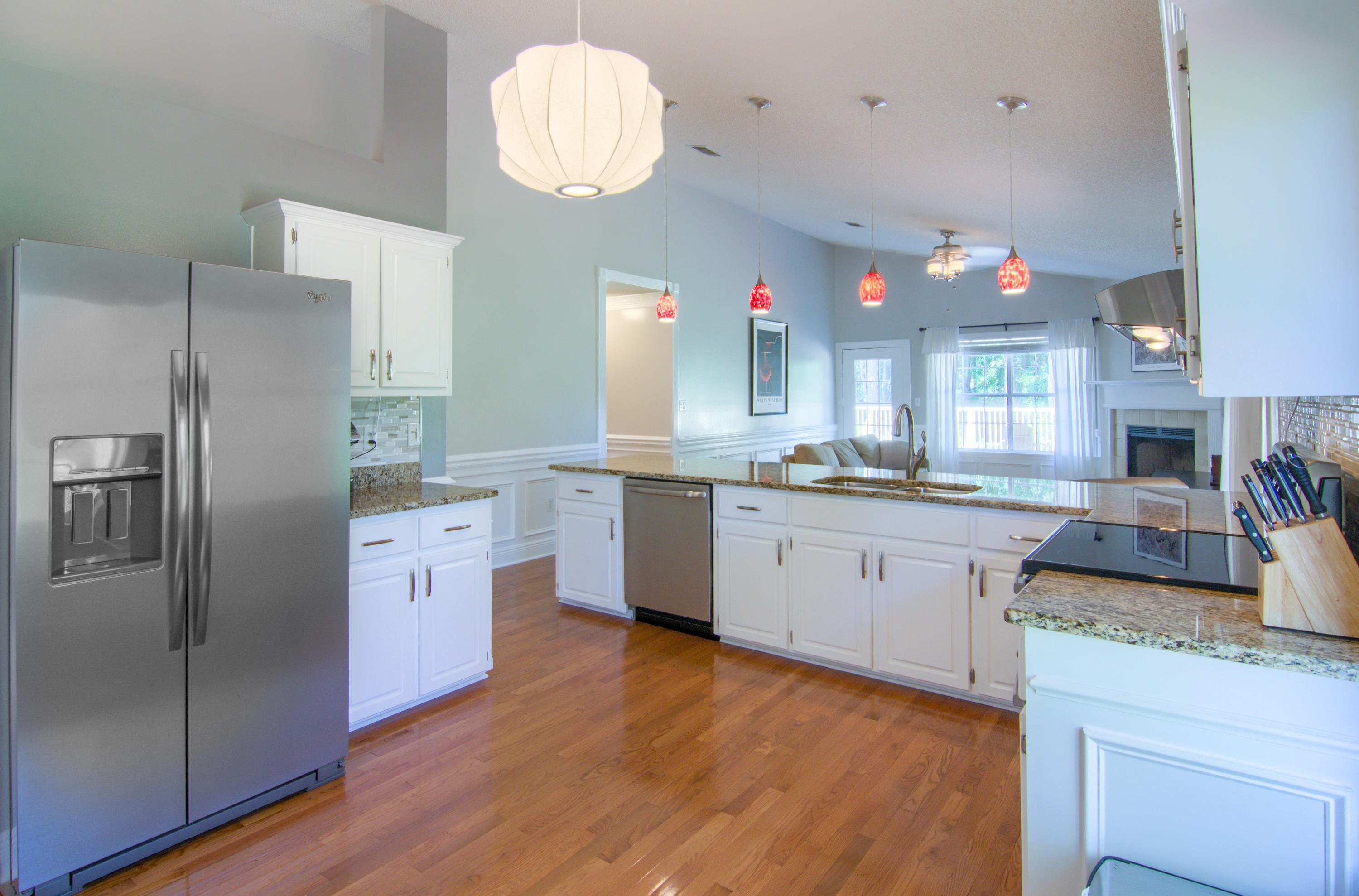 3840 Mesa Road Destin, FL 32541 - Photo 8 of 11 a kitchen with stainless steel appliances granite countertop a refrigerator a sink dishwasher a stove with wooden floors