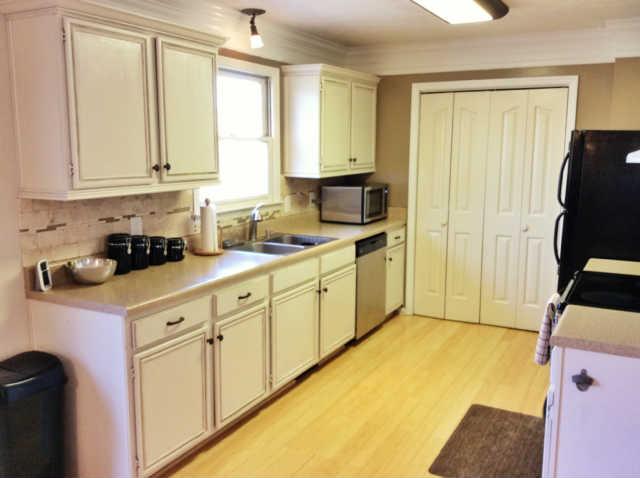 7519 King Road Fairview, TN 37062 - Photo 4 of 17 a kitchen with stainless steel appliances granite countertop a stove a sink and white cabinets