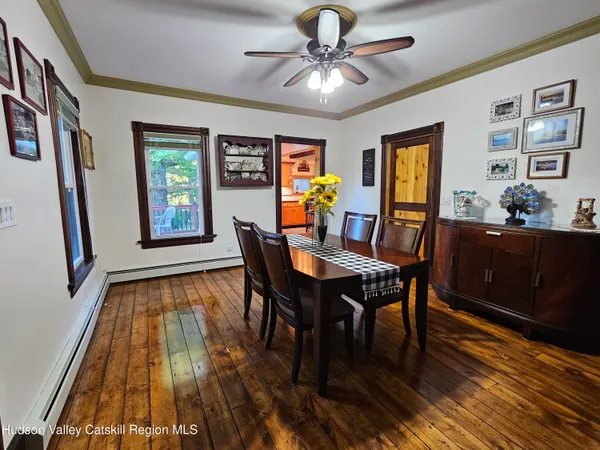 a view of a dining room with furniture and chandelier