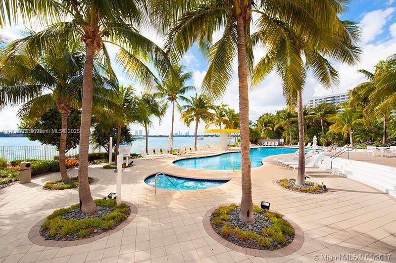 1330 West Avenue, Unit 1807 Miami Beach, FL 33139 - Photo 15 of 17 a swimming pool with outdoor seating and palm trees