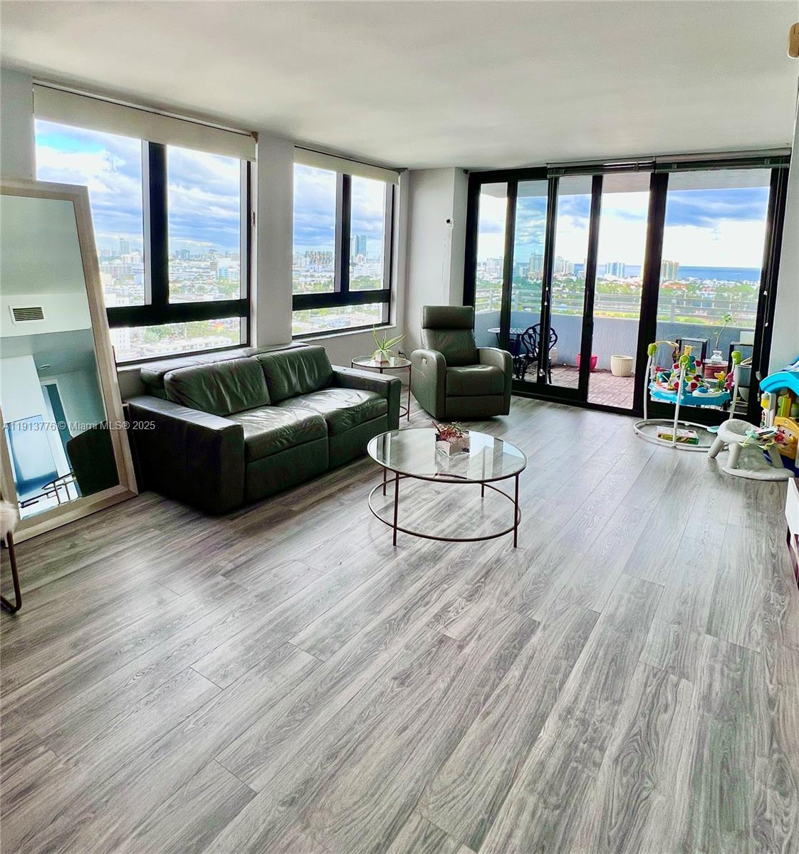 1330 West Avenue, Unit 1807 Miami Beach, FL 33139 - Photo 3 of 17 a living room with furniture and large windows