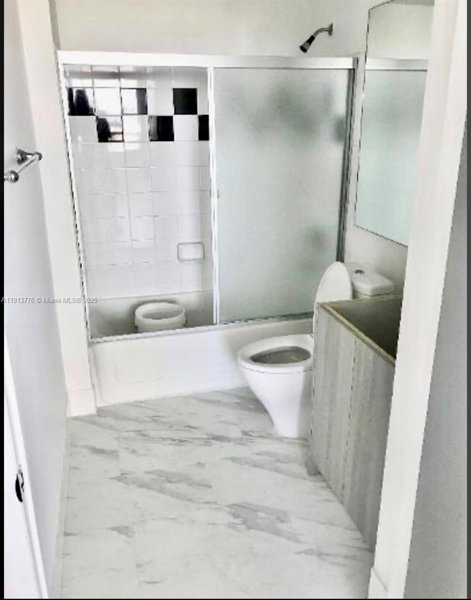 1330 West Avenue, Unit 1807 Miami Beach, FL 33139 - Photo 4 of 17 a bathroom with a sink toilet and shower