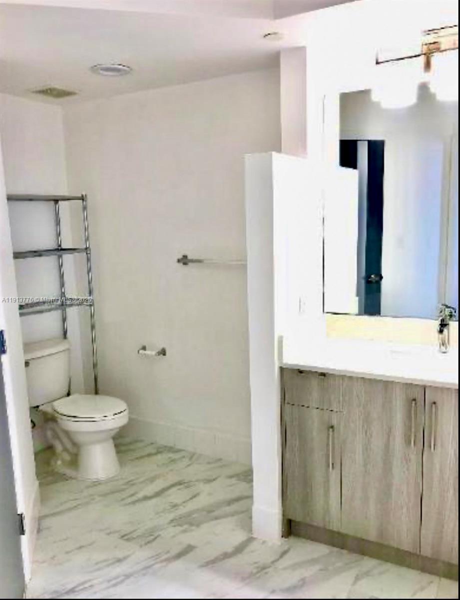 1330 West Avenue, Unit 1807 Miami Beach, FL 33139 - Photo 5 of 17 a bathroom with a sink toilet and shower