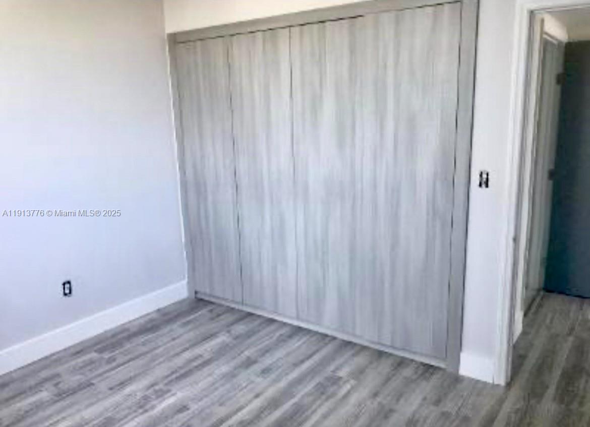 1330 West Avenue, Unit 1807 Miami Beach, FL 33139 - Photo 6 of 17 a view of a room with wooden floor and a window