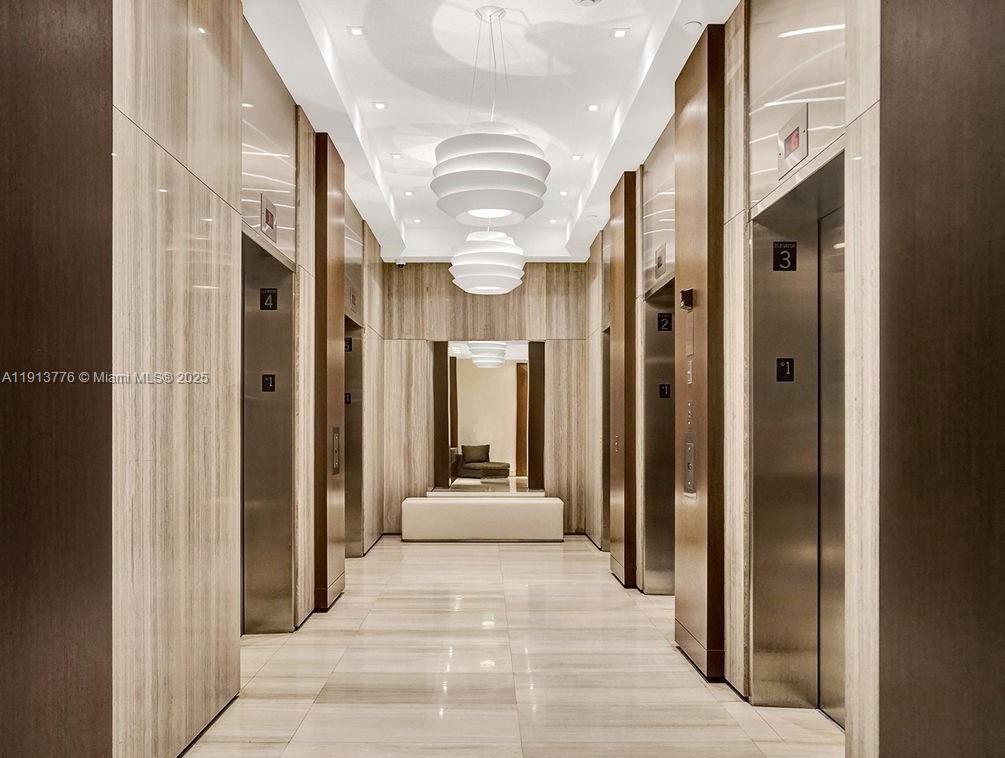 1330 West Avenue, Unit 1807 Miami Beach, FL 33139 - Photo 8 of 17 a view of a hallway with shower and a mirror