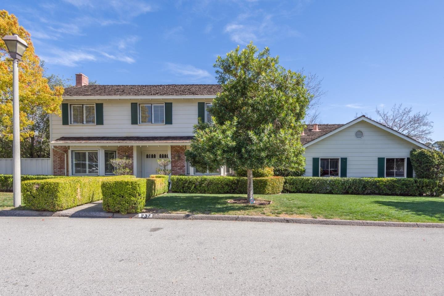 a front view of a house with a garden