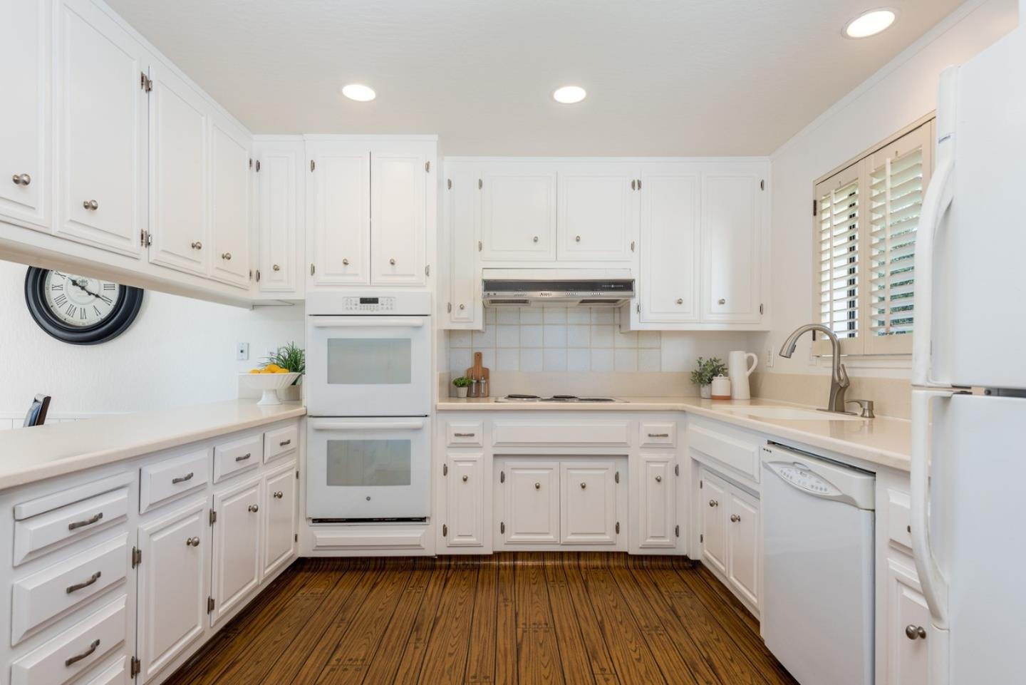 237 Timothy Drive San Carlos, CA 94070 - Photo 7 of 30 a kitchen with cabinets stainless steel appliances a sink and wooden floor