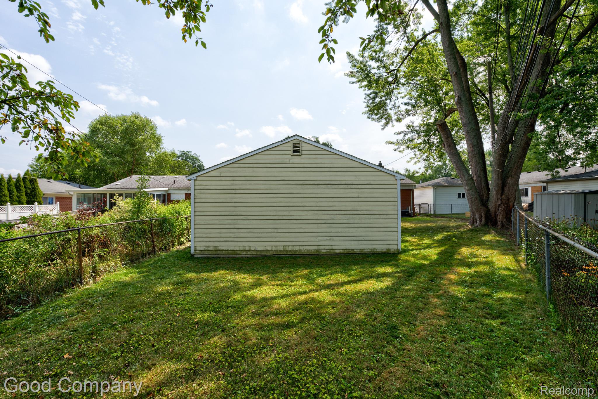1842 Massoit Road Royal Oak, MI 48073 - Photo 43 of 52 Expansive grassy yard with mature trees and perimeter fencing