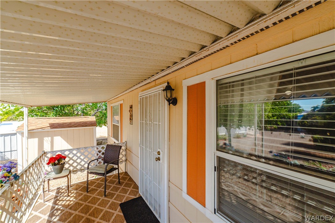 3003 Hualapai Mountain Road Kingman, AZ 86401 - Photo 3 of 49 a porch with a table and chairs in patio