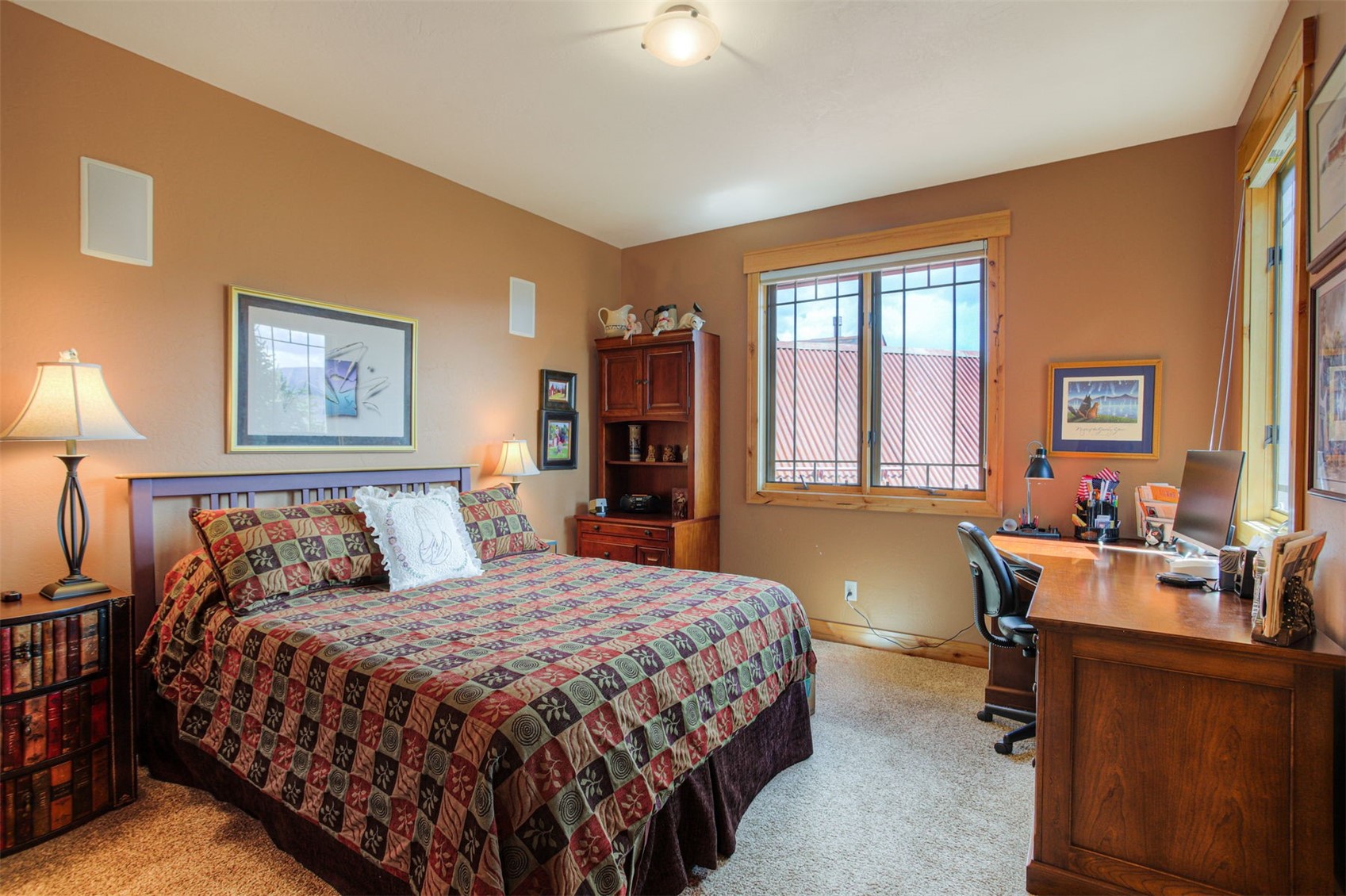 727 Willowbrook Road Silverthorne, CO 80498 - Photo 29 of 47 a bedroom with a large bed and a desk