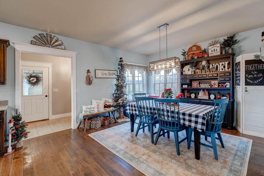 4045 Russell Road Mount Gilead, OH 43338 - Photo 19 of 74 • Handscraped hardwood flooring • Baby blue painted walls • Lighting above table • Bench seating around window
