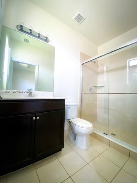 11487 Southwest 248th Lane Homestead, FL 33032 - Photo 11 of 16 a bathroom with a toilet a sink a mirror and vanity
