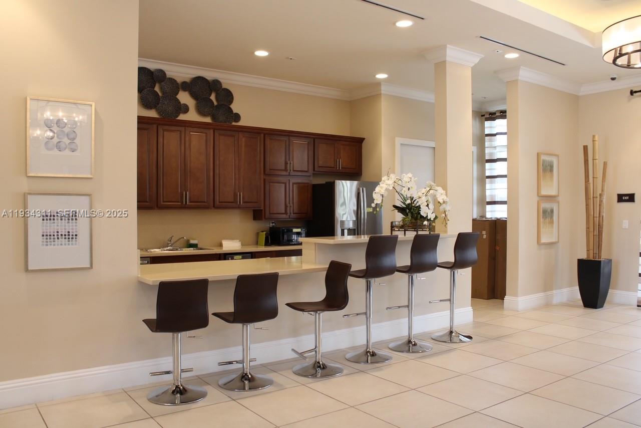 11487 Southwest 248th Lane Homestead, FL 33032 - Photo 15 of 16 a kitchen with stainless steel appliances kitchen island granite countertop a refrigerator and cabinets