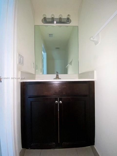 11487 Southwest 248th Lane Homestead, FL 33032 - Photo 6 of 16 a bathroom with a sink vanity and a mirror